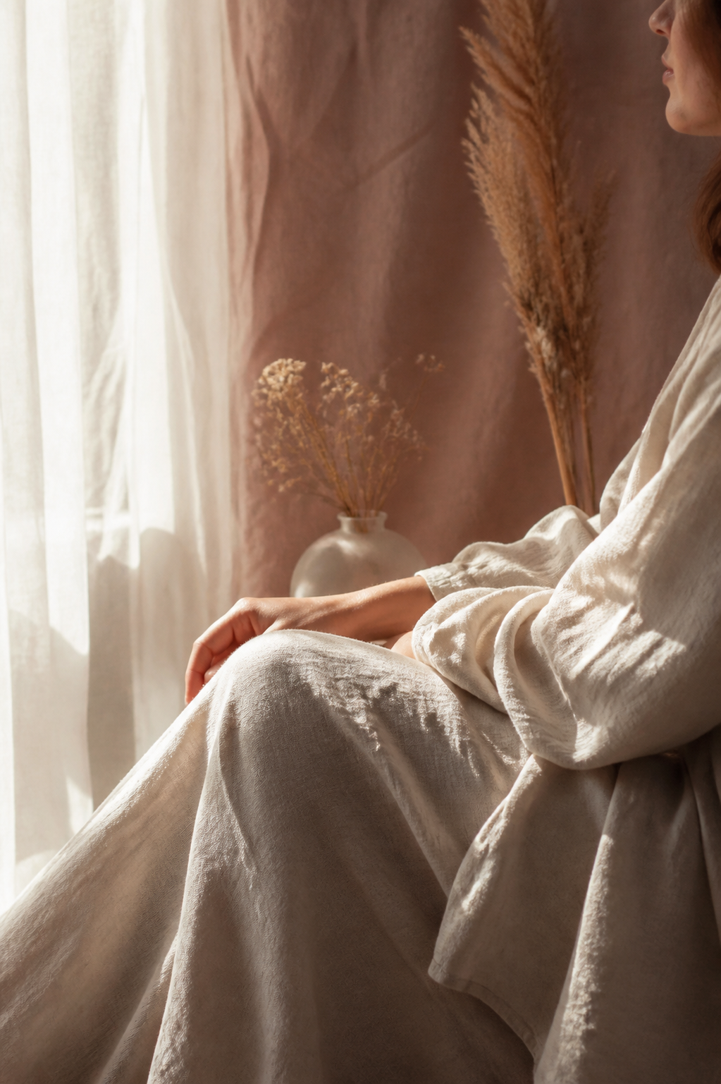 A person sitting quietly in a sunlit room